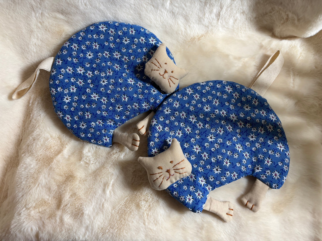 Pair of cotton cat potholders with cream paws and hanging loops