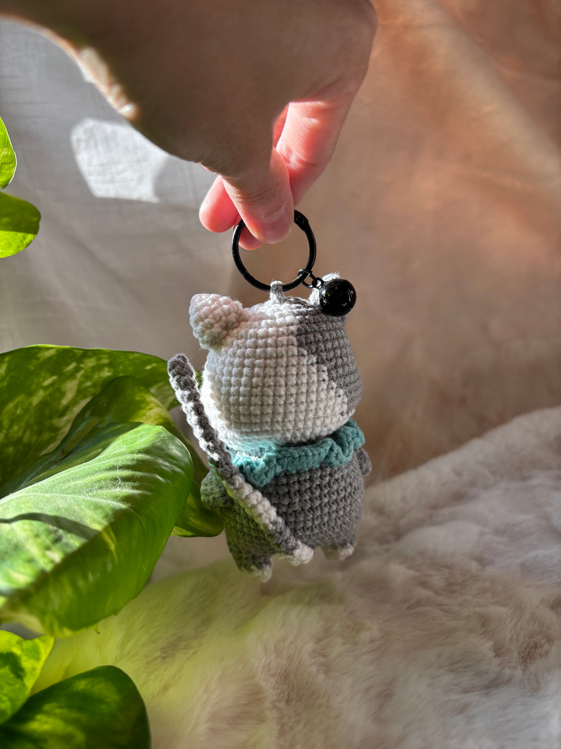 Crochet kitten keychain with mint ruffle collar, side view