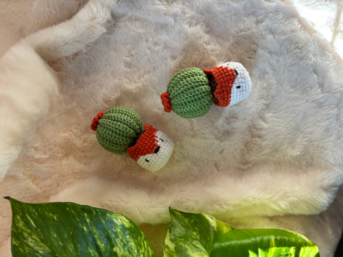 Crochet cacti in fox pots lying on a fur rug