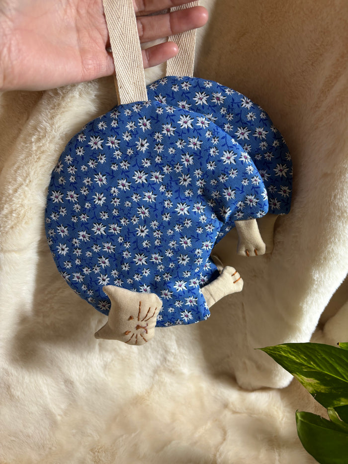 Handmade cat potholders in blue Dolomites fabric with embroidered faces