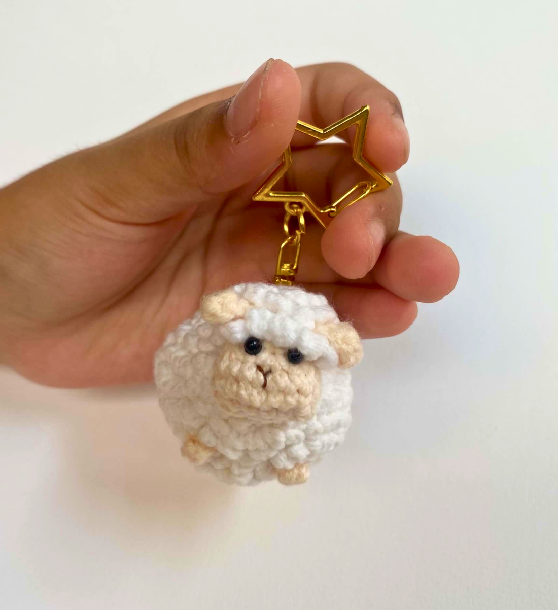 Fluffy white crochet sheep keychain with gold star clasp
