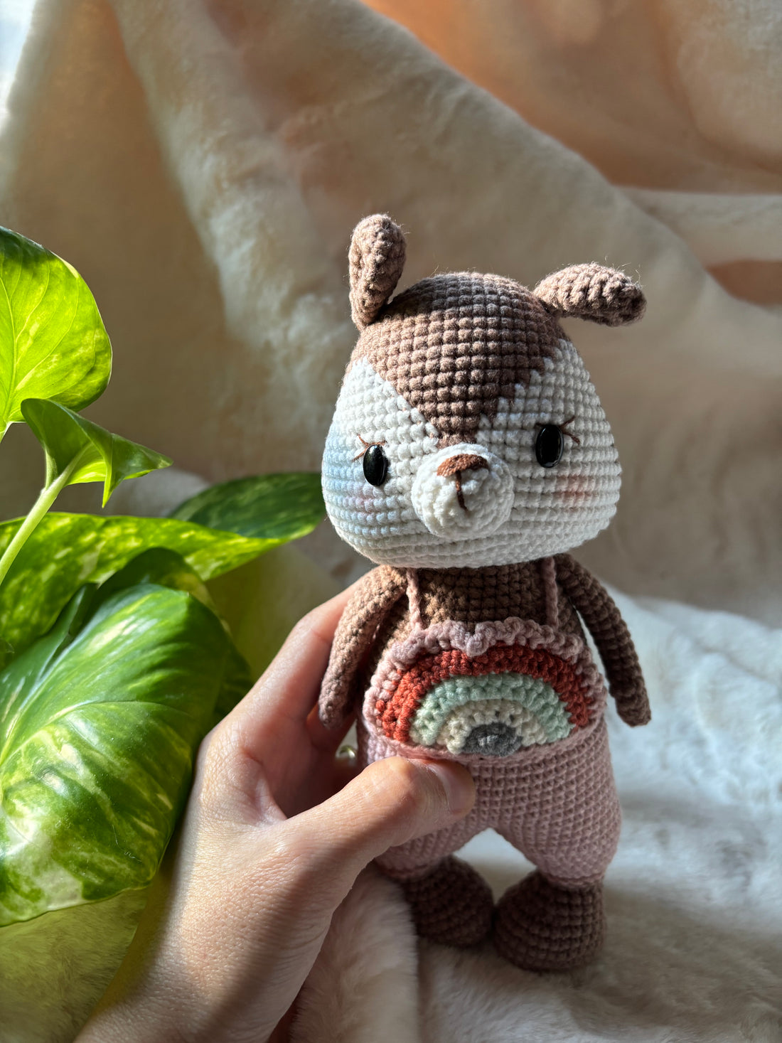 Crochet squirrel in rainbow overalls, front view