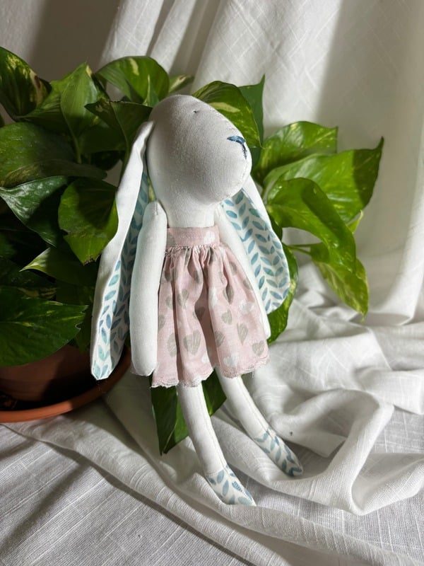 Hand-sewn fabric bunny doll in a pink skirt — Full view